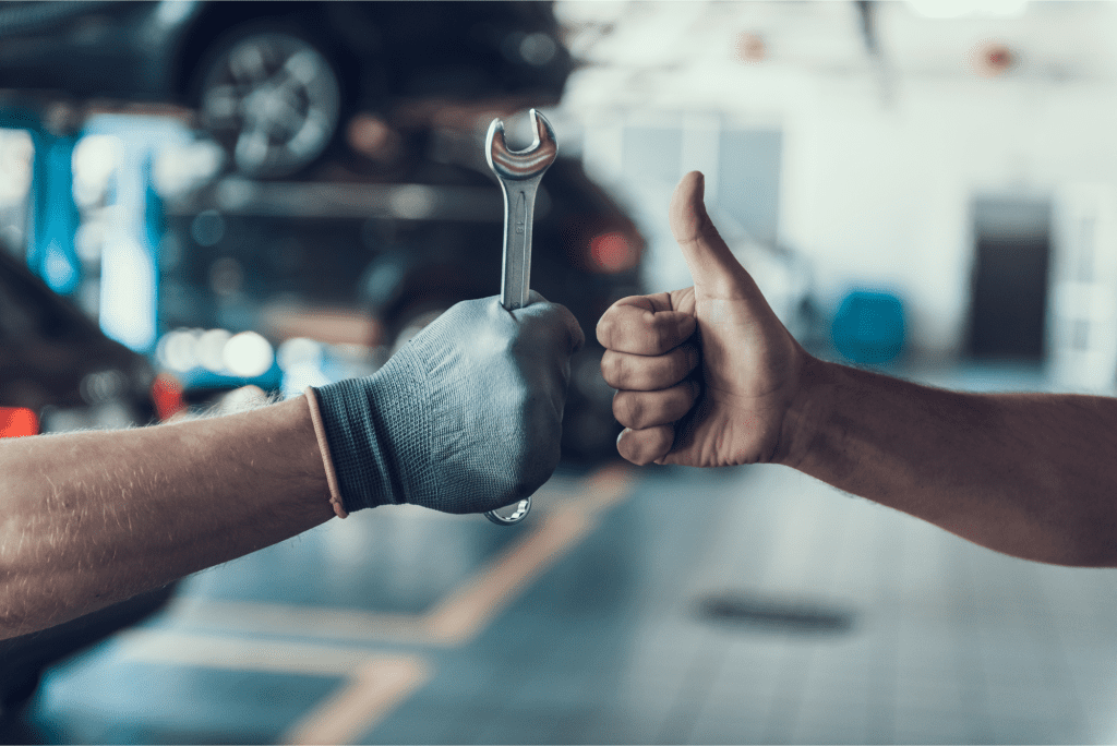 man servicing car